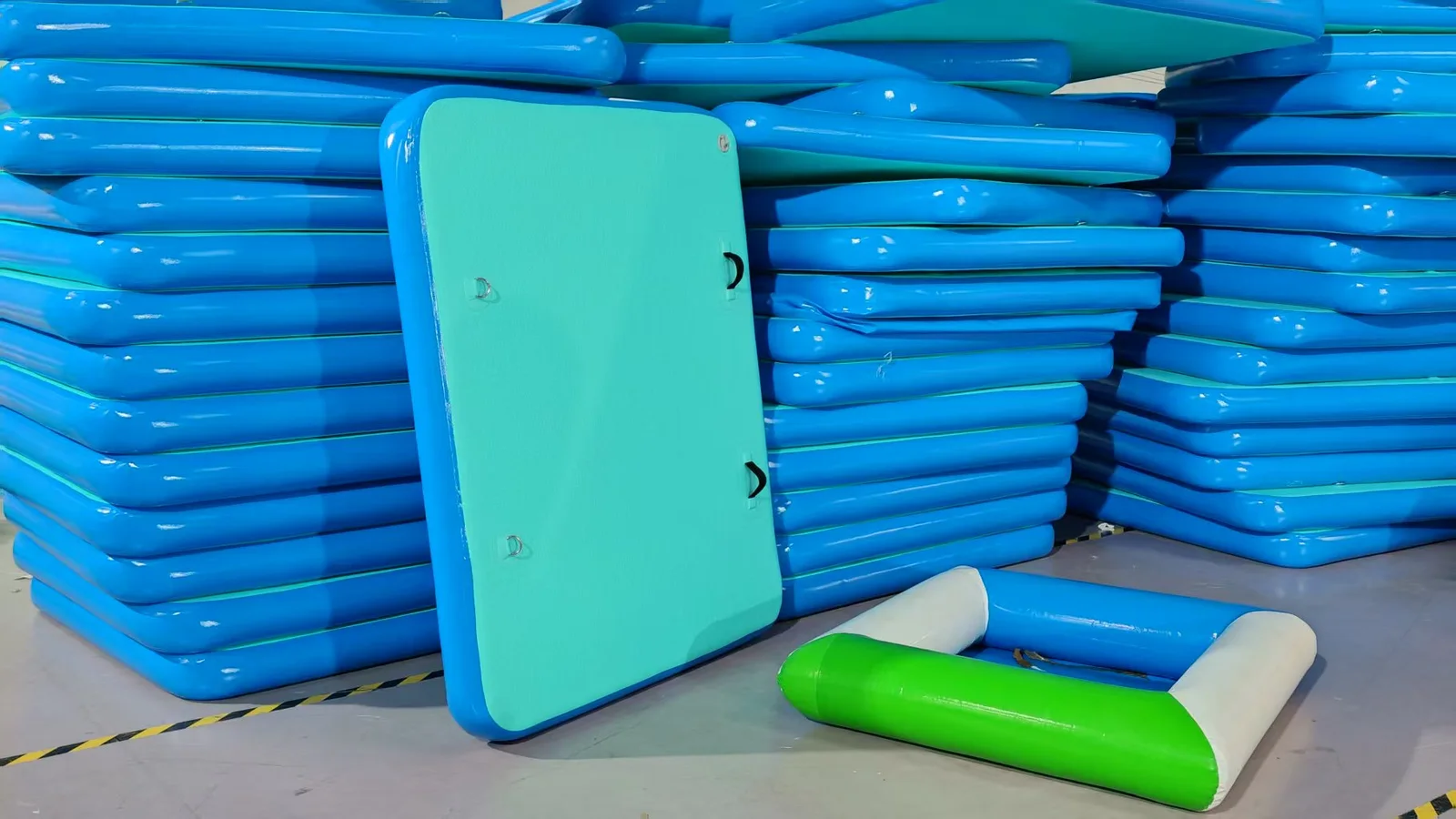 Blue and turquoise inflated platform sections arranged inside the workshop