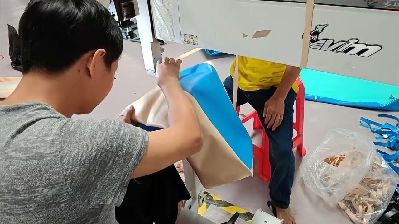 DSPR workshop team handling blue inflatable material at a machine